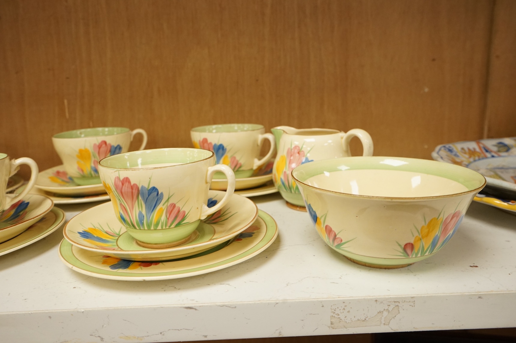 Collection of Clarice Cliff crocus pattern tea wares to include trios, milk jug, and a bowl, largest 22cm in diameter